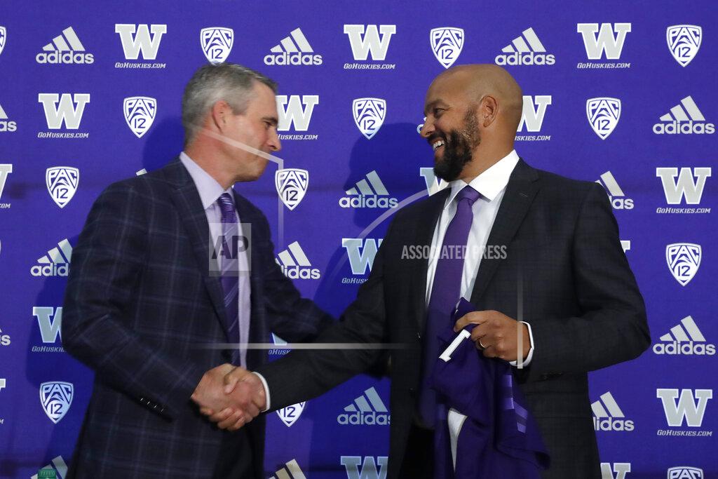 Elaine Thompson Washington NCAA college football head coach Chris Petersen, left, shakes hands with defensive coordinator Jimmy Lake following a news conference about Lake taking over the head coaching position, Tuesday, Dec. 3, 2019, in Seattle. Petersen unexpectedly resigned on Monday, a shocking announcement with the Huskies coming off a 7-5 regular season and bound for a sixth straight bowl game under his leadership. Petersen will coach Washington in a bowl game, his final game in charge. (AP Photo/Elaine Thompson)