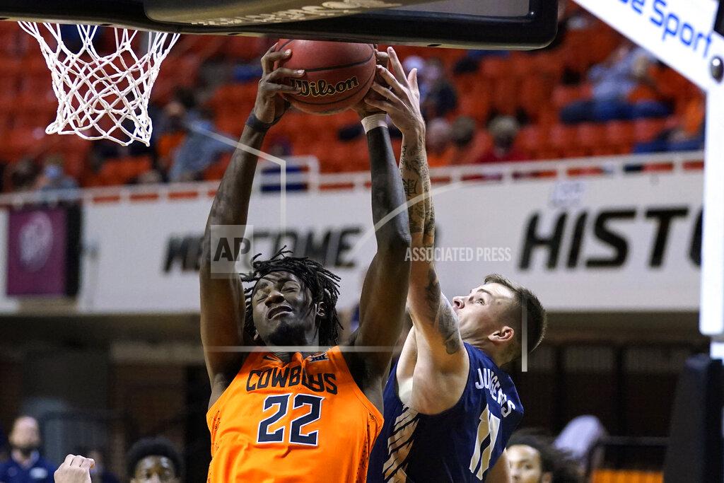 Sue Ogrocki Oklahoma State forward Kalib Boone (22) grabs a rebound next to Oral Roberts guard Carlos Jurgens (11) during the first half of an NCAA college basketball game Tuesday, Dec. 8, 2020, in Stillwater, Okla. (AP Photo/Sue Ogrocki)