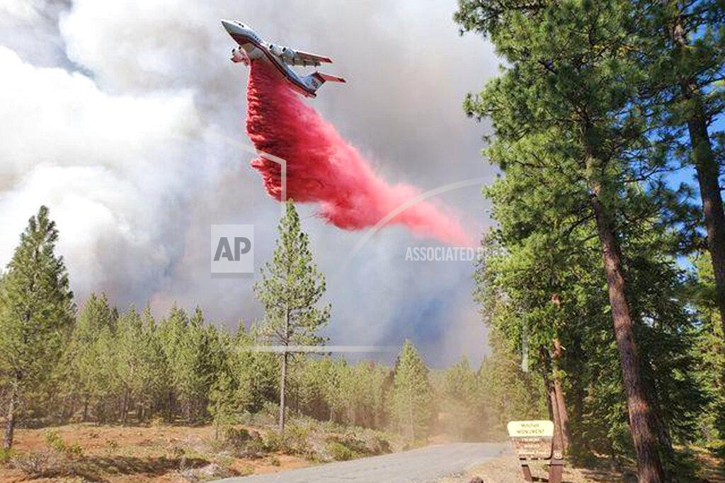 Uncredited In this photo provided by the Bootleg Fire Incident Command, a tanker drops retardant over the Mitchell Monument area at the Bootleg Fire in southern Oregon on Saturday, July 17, 2021. The 569-square-mile (1,474 square kilometers) Bootleg Fire is burning 300 miles (483 kilometers) southeast of Portland in and around the Fremont-Winema National Forest, a vast expanse of old-growth forest, lakes and wildlife refuges. (Bootleg Fire Incident Command via AP)