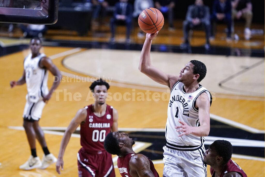 Vanderbilt forward Dylan Disu (1) shoots over South Carolina defenders in the first half of an NCAA college basketball game Saturday, Jan. 30, 2021, in Nashville, Tenn. (AP Photo/Mark Humphrey)
