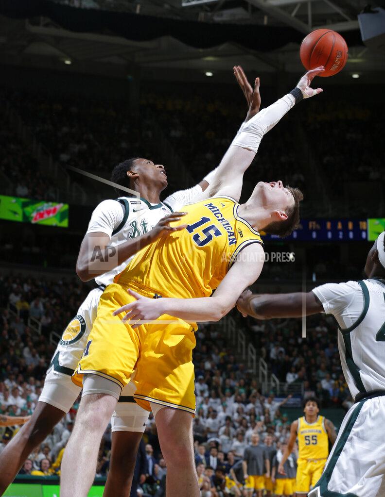 Al Goldis Michigan's Jon Teske (15) and Michigan State's Marcus Bingham Jr. reach for a rebound during the first half of an NCAA college basketball game, Sunday, Jan. 5, 2020, in East Lansing, Mich. (AP Photo/Al Goldis)