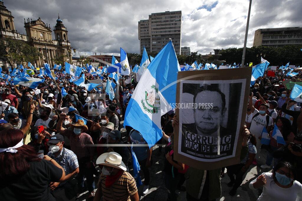 Moises Castillo Protesters gather outside Congress in Guatemala City, Saturday, Nov. 21, 2020. Hundreds of protesters were protesting in various parts of the country Saturday against Guatemalan President Alejandro Giammattei and members of Congress for the approval of the 2021 budget that reduced funds for education, health and the fight for human rights. (AP Photo/Moises Castillo)