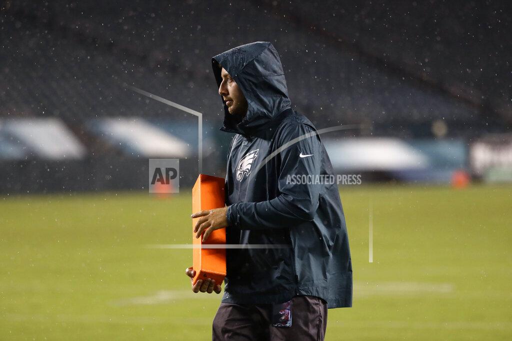 Michael Perez A worker removes sideline markers after a storm ended a preseason NFL football game between the Philadelphia Eagles and the Baltimore Ravens, Thursday, Aug. 22, 2019, in Philadelphia. (AP Photo/Michael Perez)