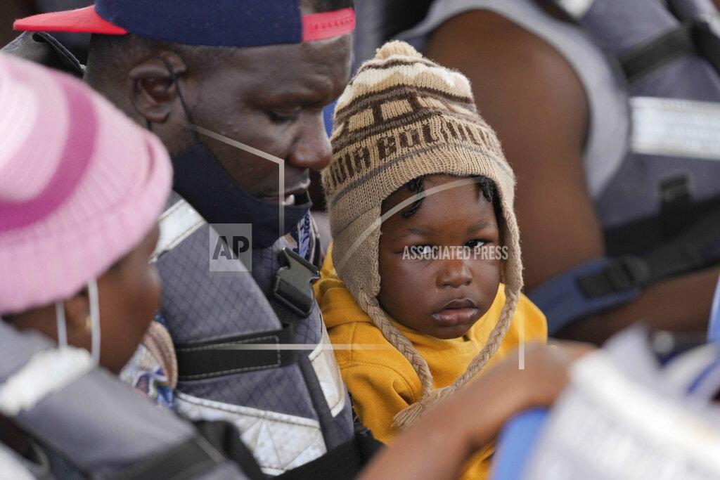 Fernando Vergara Haitian migrants sit in a boat that will take them from Necocli to Acandi, Colombia, near the border with Panama, Monday, Sept. 13, 2021. Migrants have been gathering in Necocli as they move north on their journey to the U.S. border. (AP Photo/Fernando Vergara)