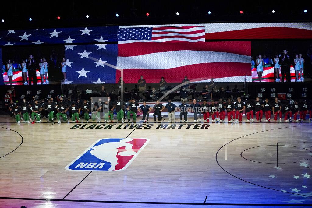 Ashley Landis Members of the Boston Celtics and Washington Wizards kneel before the start of an NBA basketball game Thursday, Aug. 13, 2020 in Lake Buena Vista, Fla. (AP Photo/Ashley Landis, Pool)