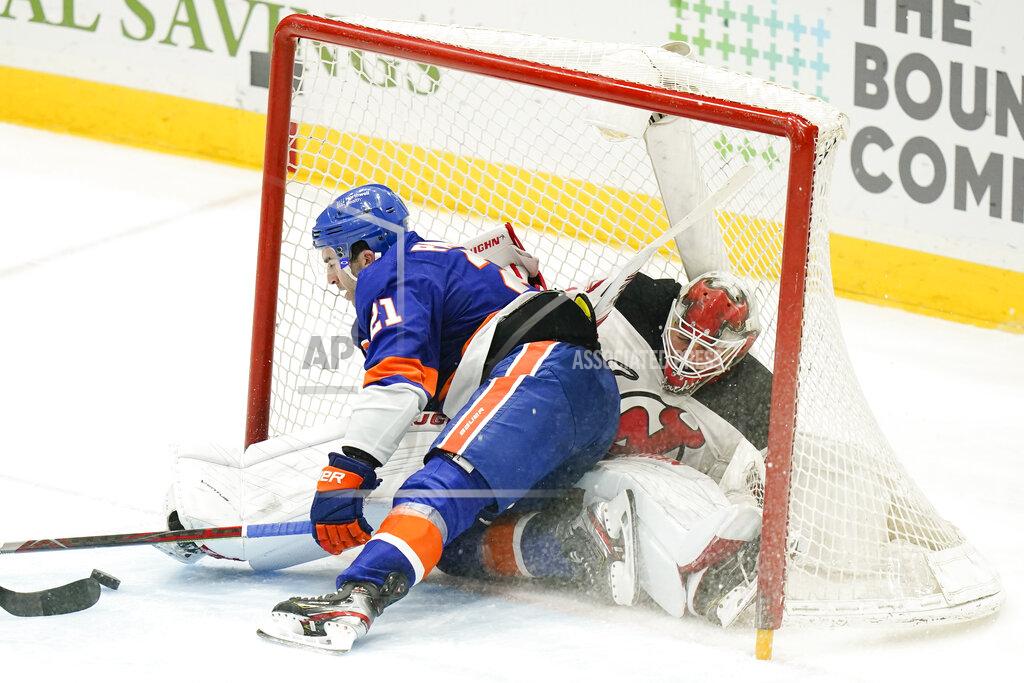Frank Franklin Ii New York Islanders' Kyle Palmieri (21) crashes into New Jersey Devils goaltender Mackenzie Blackwood (29) while scoring a goal during the third period of an NHL hockey game Saturday, May 8, 2021, in Uniondale, N.Y. The Islanders won 5-1. (AP Photo/Frank Franklin II)