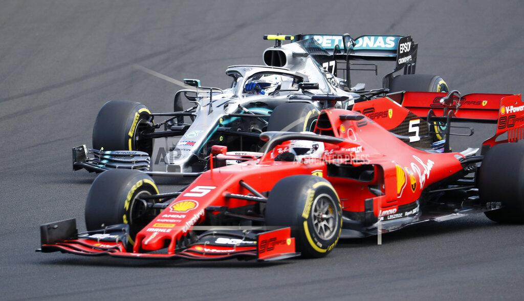 Laszlo Balogh Ferrari driver Sebastian Vettel, bottom, of Germany, leads Mercedes driver Valtteri Bottas, foreground, of Finland, during the Hungarian Formula One Grand Prix at the Hungaroring racetrack in Mogyorod, northeast of Budapest, Hungary, Sunday, Aug. 4, 2019. (AP Photo/Laszlo Balogh)