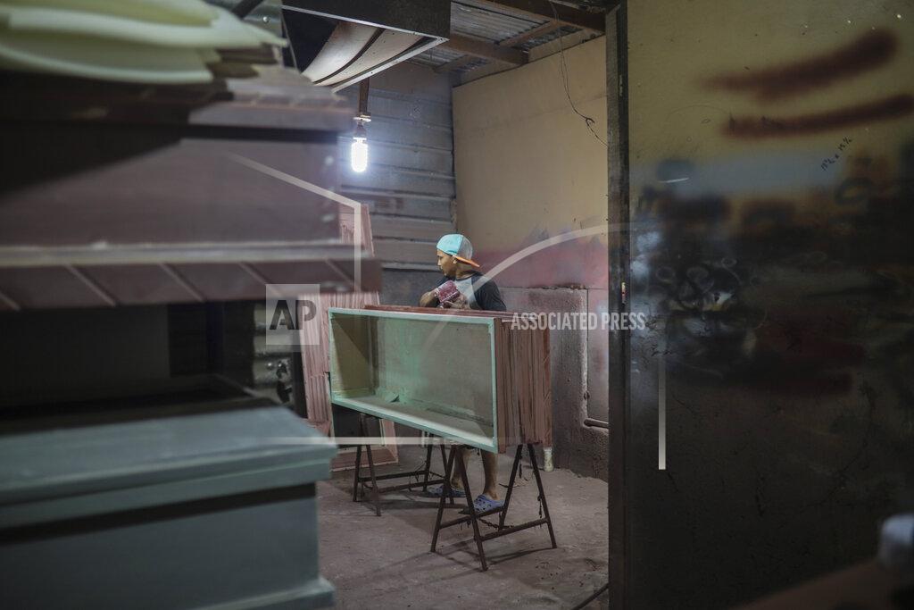Alfredo Zuniga A man builds coffins at the La Amistad funeral home in Managua, Nicaragua, Wednesday, May 27, 2020. President Daniel Ortega's government has stood out for its refusal to impose measures to halt the coronavirus since the disease was first diagnosed in Nicaragua. Now, doctors and family members of apparent victims say, the government has gone from denying the disease's presence in the country to actively trying to conceal its spread. (AP Photo/Alfredo Zuniga)