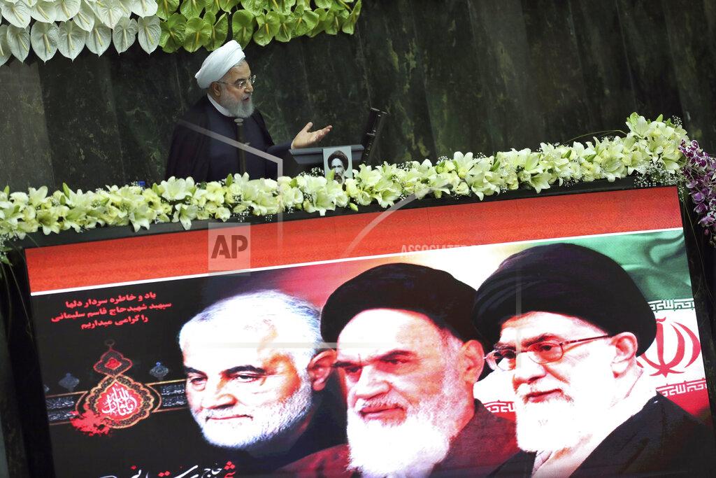 Vahid Salemi Iranian President Hassan Rouhani speaks during the inauguration of the new parliament, as a screen shows portraits of the Supreme Leader Ayatollah Ali Khamenei, right, late revolutionary founder Ayatollah Khomeini, center, and Gen. Qassem Soleimani, who was killed in Iraq in a U.S. drone attack in early January, in Tehran, Iran, Wednesday, May, 27, 2020. Iran has convened its newly elected parliament, dominated by conservative lawmakers and under strict social distancing regulations, as the country struggles to curb the spread of coronavirus that has hit the nation hard. (AP Photo/Vahid Salemi)