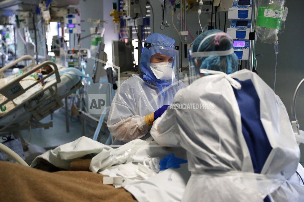 Armando Franca Nurses tend to a patient in a COVID-19 Intensive Care Unit at the Curry Cabral hospital in Lisbon, Thursday, Feb. 11, 2021. After Portugal figured for about two weeks last month as the world’s worst-hit country by size of population, anxiety over the recent pandemic peak has eased slightly. The number of COVID-19 patients in hospital and in intensive care fell Thursday for the third straight day. The health ministry reported the fewest hospitalizations since Jan. 20 and the fewest patients in ICUs for almost two weeks. (AP Photo/Armando Franca)