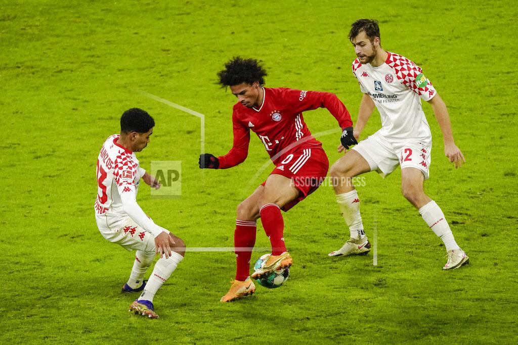 Guenter Schiffmann Bayern Munich's German forward Leroy Sane vies for the ball with Mainz' Austrian defender Philipp Mwene, left, and Mainz's German defender Alexander Hack during the German first division Bundesliga football match between FC Bayern Munich and Mainz 05 in Munich, Germany, Sunday Jan. 3, 2021. (Guenter Schiffmann/Pool via AP)