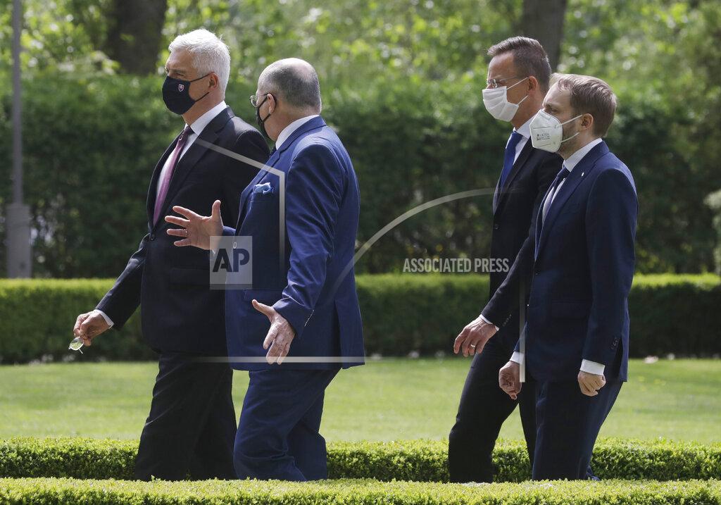 Czarek Sokolowski Slovak Foreign Minister Ivan Korcok,left,, Polish Foreign Minister Zbigniew Rau ,Hungarian Foreign Minister Peter Szijjarto and Czech Republic Foreign Minister Tomas Petricek ,right, walk after the foreign ministers of the Visegrad Group ,V4, meeting in Lodz, Poland, Friday, May 14, 2021.(AP Photo/Czarek Sokolowski)