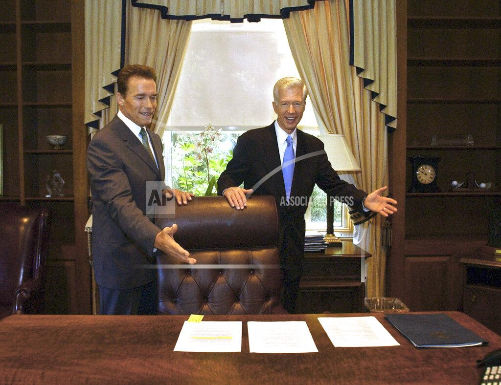 Rich Pedroncelli FILE — In this Oct. 23, 2003 file photo, Gov.-elect Arnold Schwarzenegger, left, and Gov. Gray Davis joke with each other as Davis shows Schwarzenegger the governor's private office at the Capitol in Sacramento, Calif. The two met for the first time since the voters elected Schwarzenegger to replace Gov. Gray Davis in the historic 2003 recall election. Today's California electorate is less Republican and more Asian and Latino than it was 18 years ago, trends that favor Newsom. (AP Photo/Rich Pedroncelli, File)