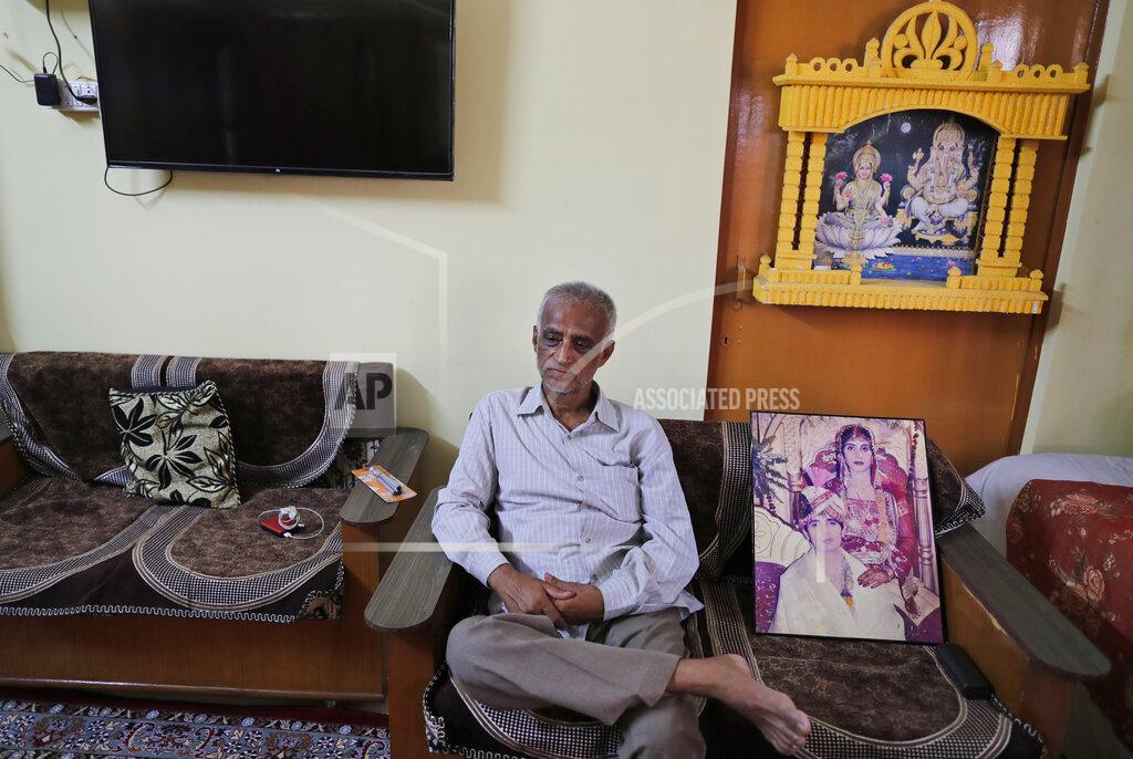 Rajesh Kumar Singh Radha Gobindo Pramanik sits by a portrait of his daughter on her wedding day, Thursday, June 3, 2021, in Lucknow, India. Two months ago Pramanik and his wife threw a party to celebrate their daughter's pregnancy and the upcoming birth of their long-awaited grandchild. They were so happy that they paid little attention to his wife's cough. Within days, his wife, his daughter and his unborn grandchild were all dead, among the tens of thousands killed as the coronavirus ravaged India in April and May. (AP Photo/Rajesh Kumar Singh)