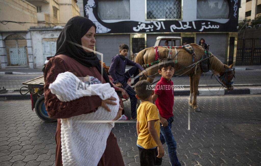 Khalil Hamra Palestinians flee their homes after overnight Israeli heavy missile strikes on their neighborhoods in the outskirts of Gaza City, Friday, May 14, 2021. (AP Photo/Khalil Hamra)