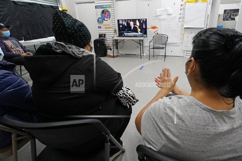 Kathy Willens Blanca Cedillos, left, a nanny, and Graciela Uraga, right, a cleaning lady, applaud as they watch the inauguration of President Joe Biden on TV with other immigrants at the Workers Justice Center, a Brooklyn non-rpofit that helps immigrants, Wednesday, Jan. 20, 2021, in the Sunset Park neighborhood of Brooklyn in New York. (AP Photo/Kathy Willens)
