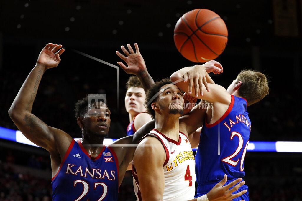 Charlie Neibergall Iowa State forward George Conditt IV, center, fights for a rebound with Kansas' Silvio De Sousa, left, and Michael Jankovich, right, during the second half of an NCAA college basketball game Wednesday, Jan. 8, 2020, in Ames, Iowa. Kansas won 79-53. (AP Photo/Charlie Neibergall)
