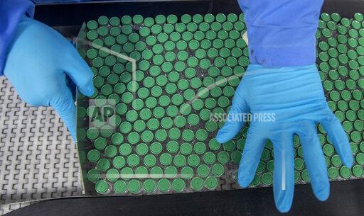 An employee packs a box containing vials of Covishield, a version of the AstraZeneca vaccine, at the Serum Institute of India in Pune, Monday, Nov. 22, 2021. The world's largest vaccine maker resumed exports of coronavirus vaccines to the U.N.-backed COVAX distribution program on Friday after halting most overseas sales in March. The company was COVAX's main supplier, but an explosion of cases in India saw most exports stopping since March. At the time, COVAX was depending on Serum Institute for nearly 1 billion doses of its version of the AstraZeneca vaccines. (AP Photo/Rafiq Maqbool)