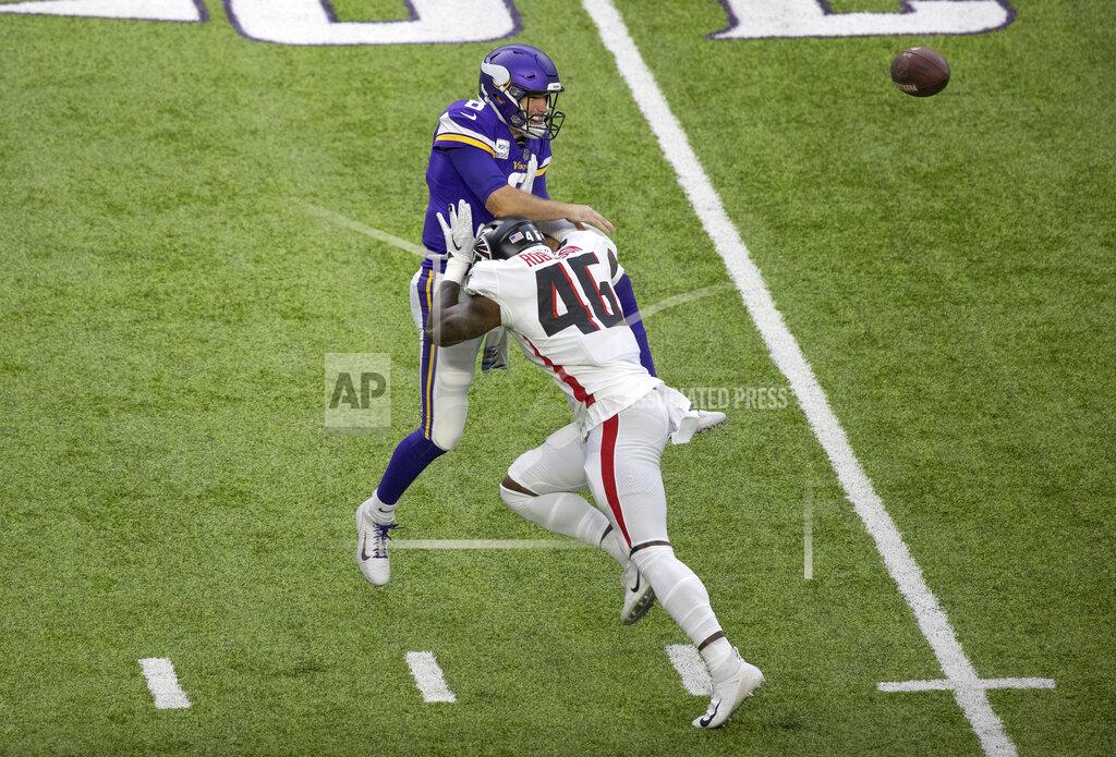 Jerry Holt Minnesota Vikings quarterback Kirk Cousins (8) is hit, forcing an incomplete pass, by Atlanta Falcons linebacker Edmond Robinson (46) in the first quarter of an NFL football game in Minneapolis, Sunday, Oct. 18, 2020. (Jerry Holt/Star Tribune via AP)
