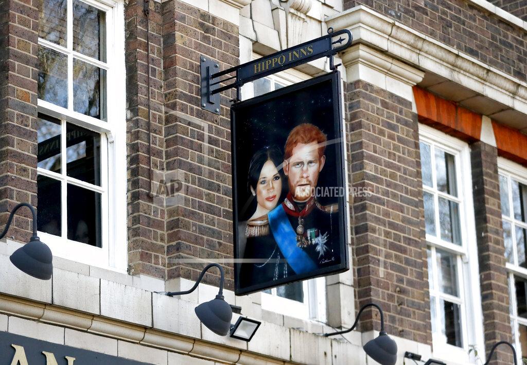 Frank Augstein A sign depicting the image of Britain's Prince Harry and his wife Meghan, hangs outside the Duke of Sussex pub near Waterloo station, London, Tuesday March 9, 2021. Prince Harry and Meghan's explosive TV interview has divided people around the world, rocking an institution that is struggling to modernize with claims of racism and callousness toward a woman struggling with suicidal thoughts. (AP Photo/Frank Augstein)