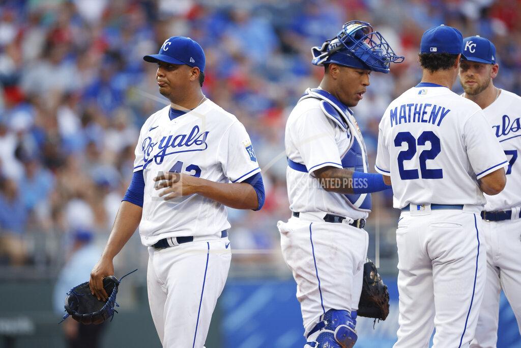 Colin E. Braley Kansas City Royals pitcher Carlos Hernandez, left, walks to the dugout after being taken out in the fourth inning of a baseball game against the Detroit Tigers at Kauffman Stadium in Kansas City, Mo., Saturday, July 24, 2021. Royals manager Mike Matheny (22) catcher Salvador Perez, second from left, and third baseman Hunter Dozier, right, stand on the mound. (AP Photo/Colin E. Braley)