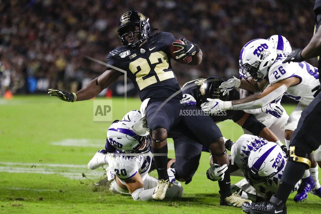 Michael Conroy Purdue running back King Doerue (22) is tackled by TCU linebacker Garret Wallow (30), safety Vernon Scott (26) and another defender during the second half of an NCAA college football game in West Lafayette, Ind., Saturday, Sept. 14, 2019. (AP Photo/Michael Conroy)