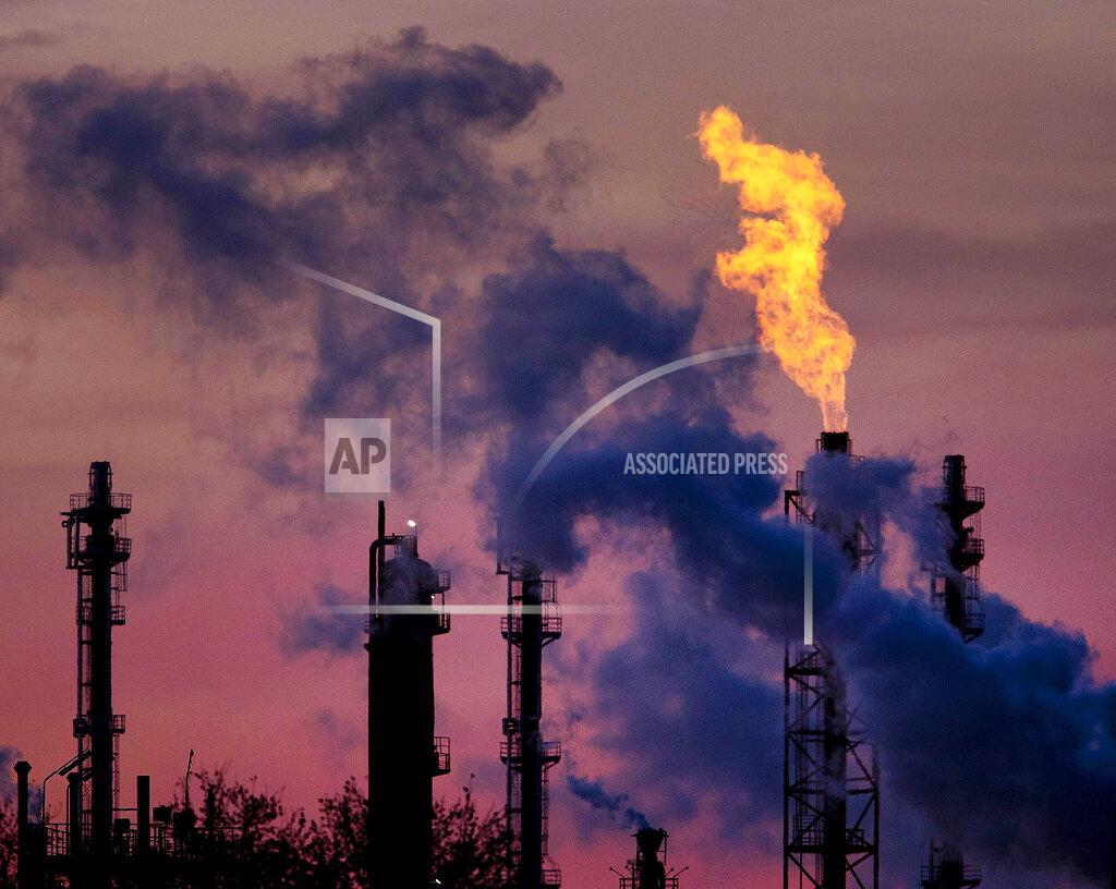 Michael Probst FILE - In this Dec.4, 2018 file photo a flame emits from a chimney at the BASF chemical company in Ludwigshafen, Germany, (AP Photo/Michael Probst, file)