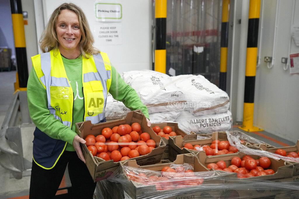 Frank Augstein Rachel Ledwith from the charity 'The Felix Project' collects food at their storage hub in London, Wednesday, May 4, 2022. Across Britain, food banks and community food hubs that helped struggling families, older people and the homeless during the pandemic are now seeing soaring demand. The cost of food and fuel in the U.K. has risen sharply since late last year, with inflation reaching the highest level in 40 years. (AP Photo/Frank Augstein)