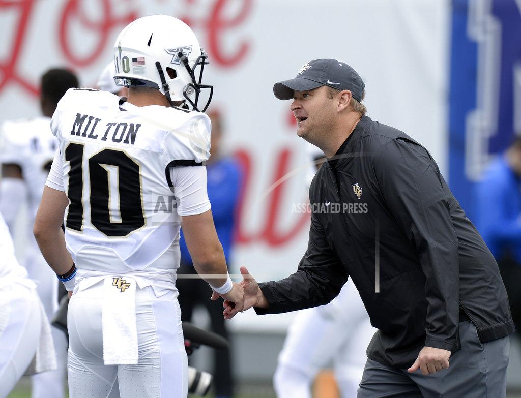 Mark Zaleski Central Florida head coach Josh Heupel shakes hands with quarterback McKenzie Milton (10) during warm ups before an NCAA college football game against Memphis Saturday, Oct. 13, 2018, in Memphis, Tenn. (AP Photo/Mark Zaleski)