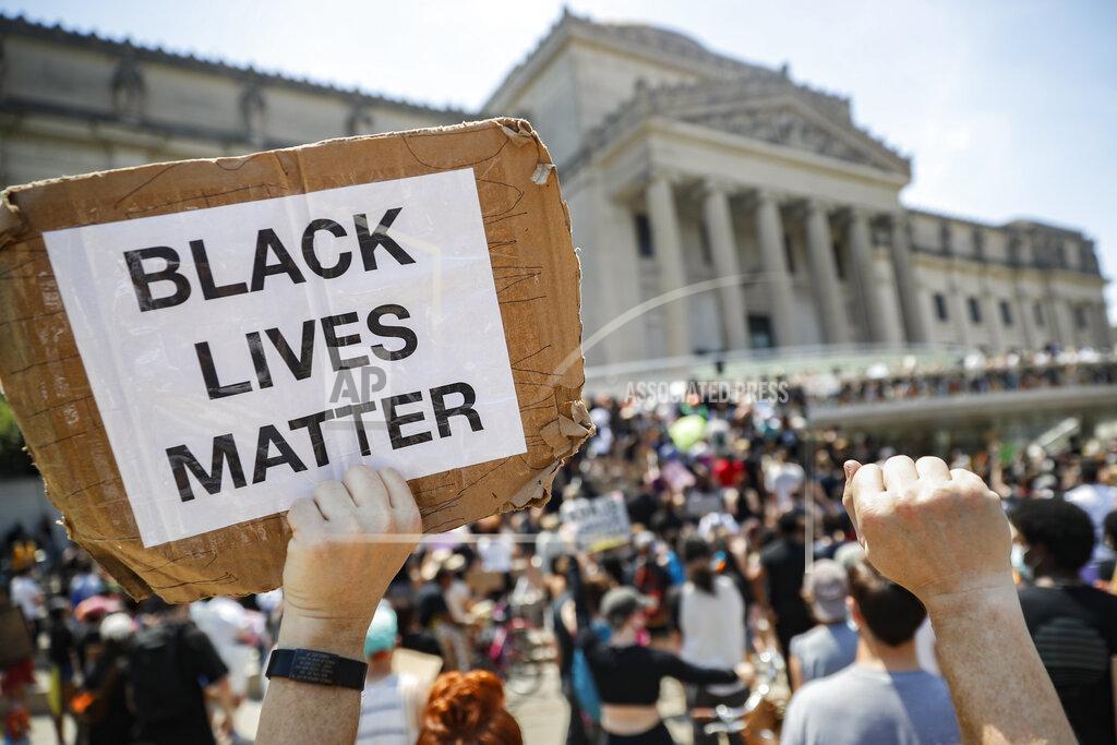 John Minchillo FILE - In this Friday, June 19, 2020 file photo, a protester holds a sign that reads "BLACK LIVES MATTER" during a Juneteenth rally outside the Brooklyn Museum, in the Brooklyn borough of New York. Juneteenth commemorates when the last enslaved African Americans learned they were free 155 years ago. Belarusian opposition figures, Hong Kong-pro-democracy activists, the Black Lives Matter movement, a jailed Russian opposition leader and two former White House senior advisers are among this year’s nominations for the Nobel Peace Prize. The 2021 deadline has passed and some of those who nominated people have spoken up. (AP Photo/John Minchillo, File)