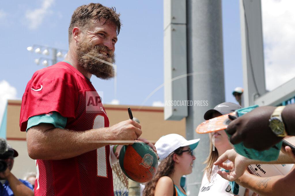 Lynne Sladky Miami Dolphins quarterback Ryan Fitzpatrick signs autographs during NFL football training camp,Thursday, July 25, 2019, in Davie, Fla. (AP Photo/Lynne Sladky)