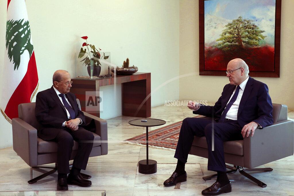Dalati Nohra In this photo released by Lebanon's official government photographer Dalati Nohra, Lebanese president Michel Aoun, left, meets with Lebanese Prime minister Najib Mikati, ahead of a cabinet meeting at the presidential palace, in Baabda, east of Beirut, Lebanon, Friday, May 20, 2022. Lebanon's government approved an economic recovery plan during its last meeting Friday before becoming a caretaker Cabinet after a new parliament was elected over the weekend, the information minister said. (Dalati Nohra/Lebanon Government via AP)