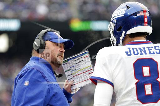 New York Giants interim offensive coordinator Freddie Kitchens talks to Daniel Jones during an NFL football game against the Philadelphia Eagles, Sunday, Nov. 28, 2021, in East Rutherford, N.J. Joe Judge isn't making the Miami Dolphins guess about who will be calling the offensive plays for the Giants this weekend. Former Cleveland Browns coach Freddie Kitchens handled the role against the Eagles after Jason Garrett was fired last week, and he's going to have the headset Sunday when the Giants visit the Dolphins. (AP Photo/Adam Hunger)