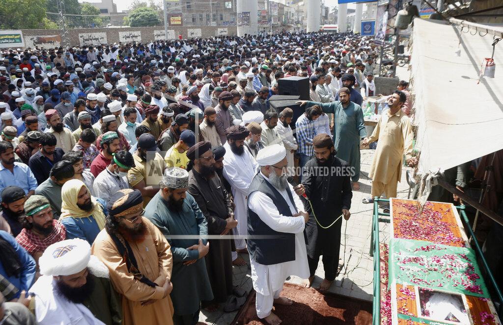 K.M. Chaudary Supporters of Tehreek-e-Labiak Pakistan, a banned Islamist party, offer the funeral prayer of their colleague, who was killed in the Sunday's clash with police, in Lahore, Pakistan, Monday, April 19, 2021. The outlawed Pakistani Islamist political group freed 11 policemen almost a day after taking them hostage in the eastern city of Lahore amid violent clashes with security forces, the country's interior minister said Monday. (AP Photo/K.M. Chaudary)