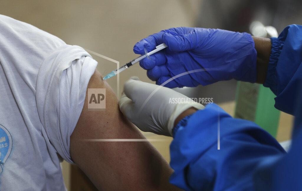 Achmad Ibrahim A man receives shot of Sinovac COVID-19 vaccine during mass vaccination in Jakarta, Indonesia. Thursday, April 15, 2021. (AP Photo/ Achmad Ibrahim)