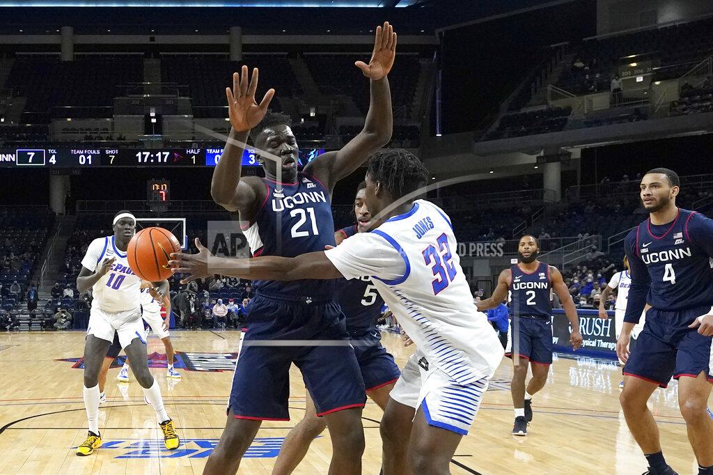 Charles Rex Arbogast DePaul's David Jones (32) is pressured by Connecticut's Adama Sanogo (21) as he passes the ball to Yor Anei during the first half of an NCAA college basketball game Saturday, Jan. 29, 2022, in Chicago. (AP Photo/Charles Rex Arbogast)