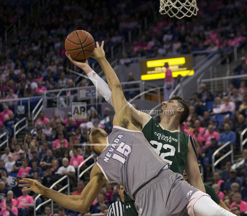 Tom R. Smedes Nevada forward Trey Porter (15) and Colorado State center Nico Carvacho (32) reach for a rebound during the first half of an NCAA college basketball game in Reno, Nev., Wednesday, Jan. 23, 2019. (AP Photo/Tom R. Smedes)
