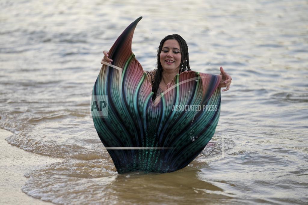 Mark Baker Lauren Metzler, founder of Sydney Mermaids, prepares for a swim at Manly Cove Beach in Sydney, Australia, Thursday, May 26, 2022. Metzler received her advanced mermaid certification this month with a goal of teaching rookie merfolk how to avoid sinking to the seabed. (AP Photo/Mark Baker)