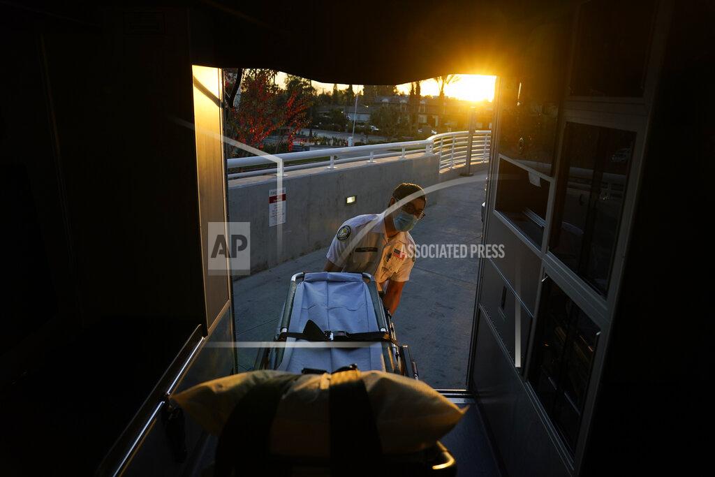 Jae C. Hong Emergency medical technician Thomas Hoang, 29, of Emergency Ambulance Service, loads a gurney into an ambulance after transporting a patient to an emergency room in Fullerton, Calif., Saturday, Jan. 9, 2021. (AP Photo/Jae C. Hong)
