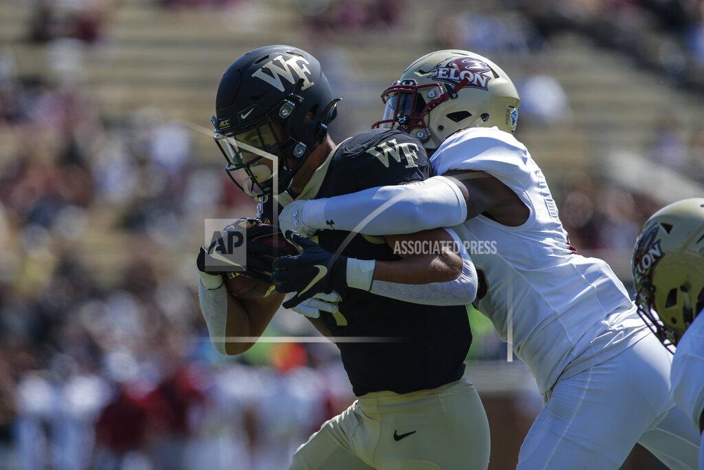 Nell Redmond Wake Forest wide receiver Sage Surratt, left, fights for yards as Elon defensive back Daniel Reid-Bennett tries to make the tackle in the first half of an NCAA college football game in Winston-Salem, N.C., Saturday, Sept. 21, 2019. (AP Photo/Nell Redmond)
