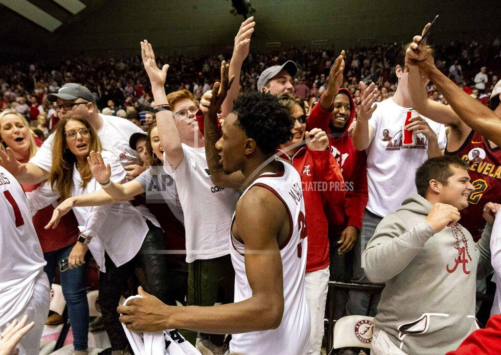 Vasha Hunt FILE - In this Jan. 5, 2019, file photo, Alabama guard/forward Tevin Mack (34) celebrates with fans after a 77-75 upset win over Kentucky after an NCAA college basketball game, in Tuscaloosa, Ala. Alabama has beaten one Top 5 team and pushed another down to the wire on the road and also suffered some humbling defeats. That inconsistency has left the Crimson Tide (15-11, 6-7 Southeastern Conference) in a precarious position in the team’s bid to make a second straight NCAA Tournament. (AP Photo/Vasha Hunt, File)