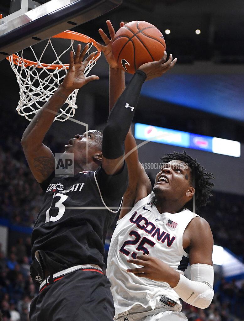 Jessica Hill Connecticut's Josh Carlton (25) blocks a shot attempt by Cincinnati's Tre Scott (13) during the second half of an NCAA college basketball game, Sunday, Feb. 24, 2019, in Hartford, Conn. (AP Photo/Jessica Hill)