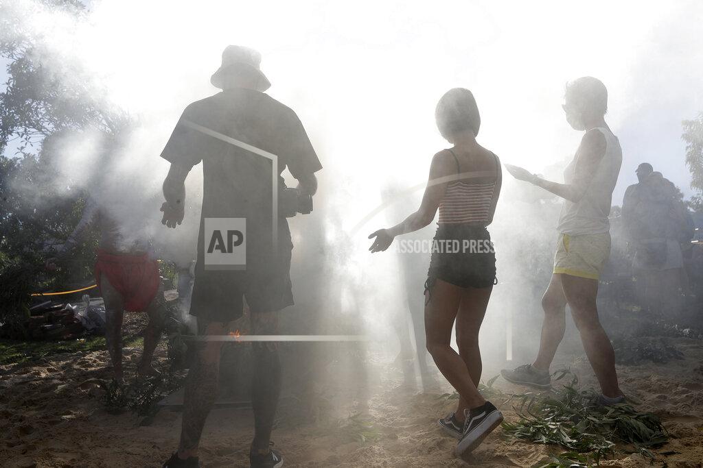 Rick Rycroft Members of the public participate in an Aboriginal smoking ceremony during Australia Day ceremonies in Sydney, Tuesday, Jan. 26, 2021. (AP Photo/Rick Rycroft)