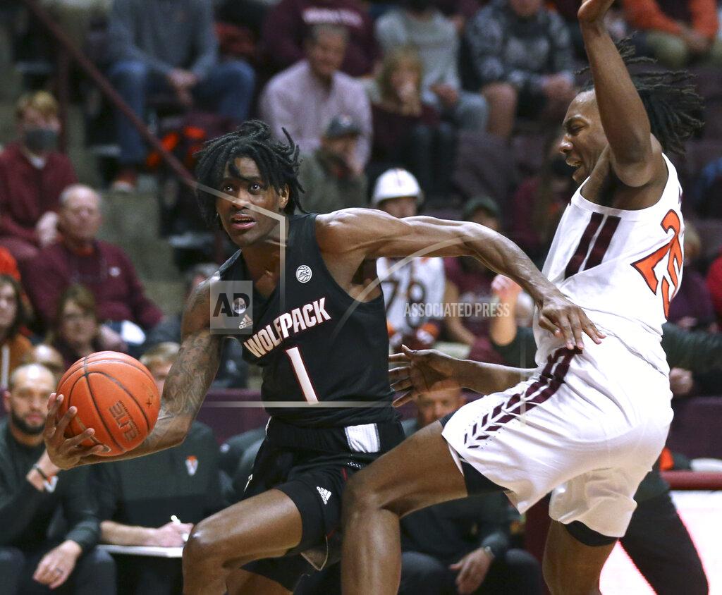 Matt Gentry North Carolina State's Dereon Seabron (1) drives past Virginia Tech's Justyn Mutts (25) in the first half of an NCAA college basketball game Tuesday, Jan. 4, 2022, in Blacksburg, Va. (Matt Gentry/The Roanoke Times via AP)