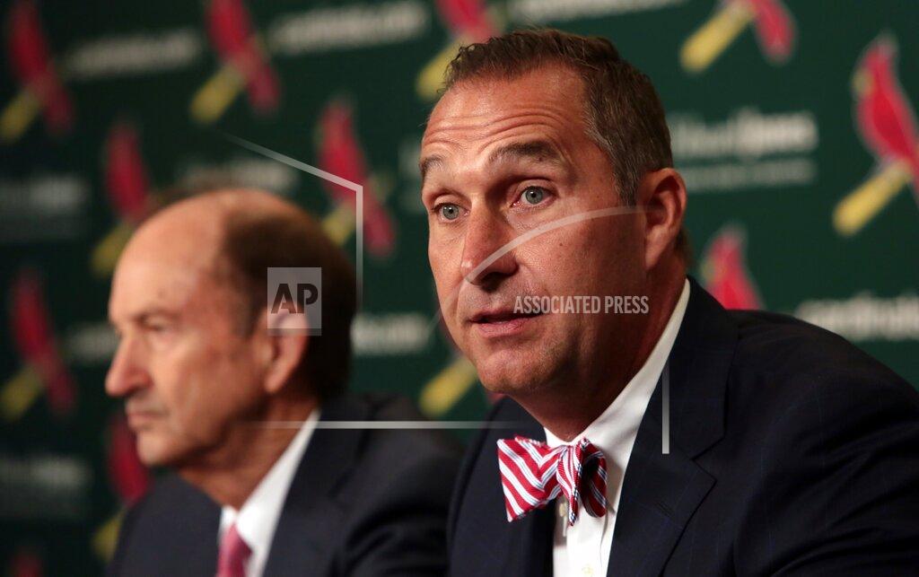 Robert Cohen FILE - In this June 30, 2017, file photo, John Mozeliak, right, newly named St. Louis Cardinals president of baseball operations, speaks during a news conference at Busch Stadium in St. Louis. St. Louis' series opener against the Chicago White Sox has been postponed to Saturday, Aug. 15, 2020, giving the Cardinals an extra day to recover from a coronavirus outbreak. The Cardinals, who have not played since July 29, were set to resume their season Friday night in Chicago. But the series opener was pushed back to a doubleheader on Saturday, the beginning of an extended stay in the Windy City for the Cards. (Robert Cohen/St. Louis Post-Dispatch via AP, File)