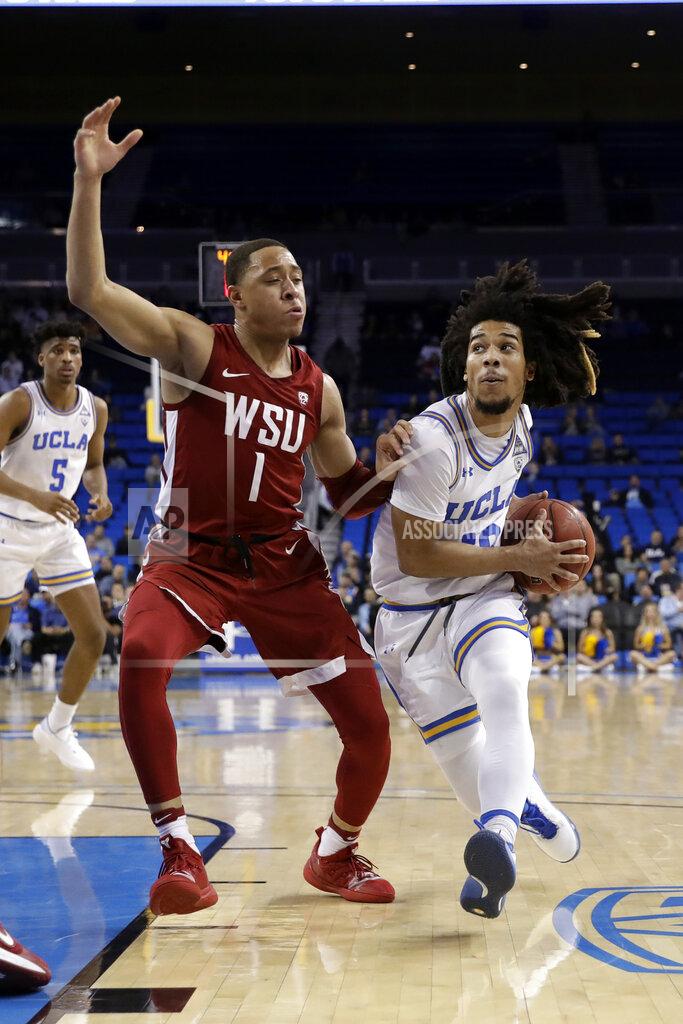 Marcio Jose Sanchez UCLA guard Tyger Campbell, right, is defended by Washington State guard Jervae Robinson (1) during the first half of an NCAA college basketball game Thursday, Feb. 13, 2020, in Los Angeles. (AP Photo/Marcio Jose Sanchez)