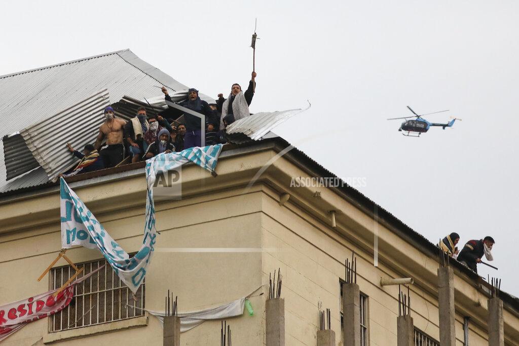 Natacha Pisarenko A police helicopter flies over rioting inmates protesting from the roof of Villa Devoto prison in Buenos Aires, Argentina, Friday, April 24, 2020. Inmates complain authorities are not doing enough to prevent the spread of coronavirus inside the prison. (AP Photo/Natacha Pisarenko)