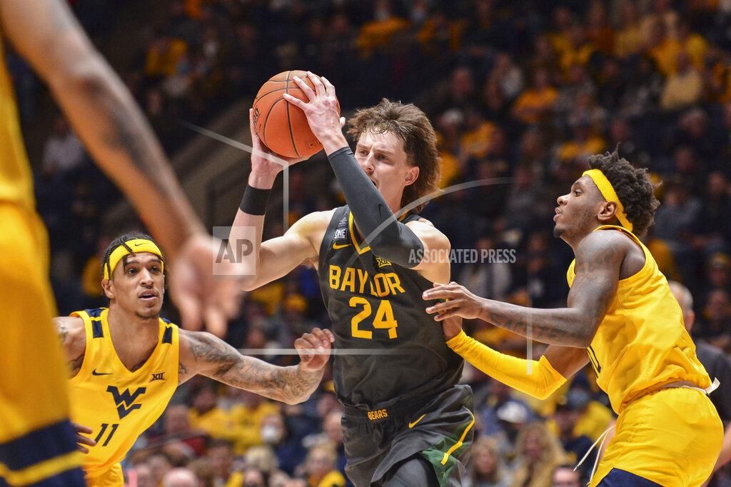 William Wotring Baylor guard Matthew Mayer (24) makes a pass while being guarded by West Virginia forward Jalen Bridges (11) during the second half of an NCAA college basketball game in Morgantown, W.Va., Tuesday, Jan. 18, 2022. (William Wotring)