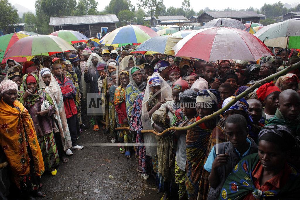 Jerome Delay In this Aug. 8, 2012, file photo, internally displaced Congolese men and women wait for a World Food Program energy biscuits to be distributed in Kibati, north of Goma, eastern Congo. The World Food Program chief warned Thursday, Sept. 17, 2020, that millions of people are closer to starvation because of the deadly combination of conflict, climate change and the COVID-19 pandemic and he urged donor nations and billionaires to help feed them and ensure their survival. (AP Photo/Jerome Delay, File)