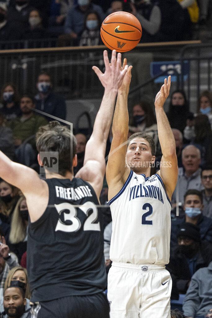 Laurence Kesterson Villanova guard Collin Gillespie (2) releases a 3-point shot over Xavier forward Zach Freemantle (32) during the first half of an NCAA college basketball game Tuesday, Dec. 21, 2021, in Villanova, Pa. (AP Photo/Laurence Kesterson)